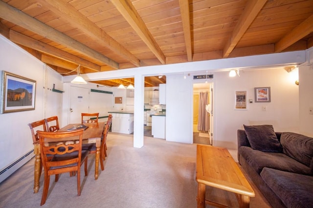 dining space with beam ceiling, a baseboard heating unit, and wood ceiling