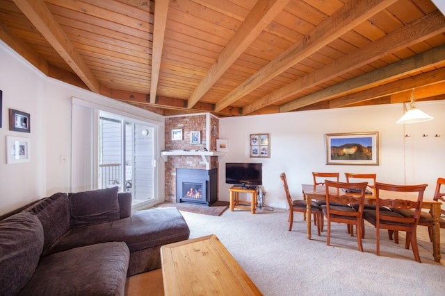 living room featuring beam ceiling, wooden ceiling, light carpet, and a brick fireplace