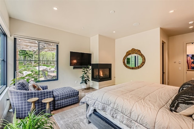 bedroom featuring baseboards, recessed lighting, and wood finished floors