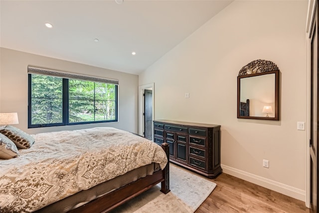 bedroom featuring light wood-type flooring, recessed lighting, baseboards, and vaulted ceiling