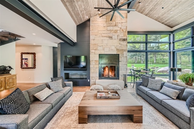 living room with a stone fireplace, high vaulted ceiling, wooden ceiling, and ceiling fan