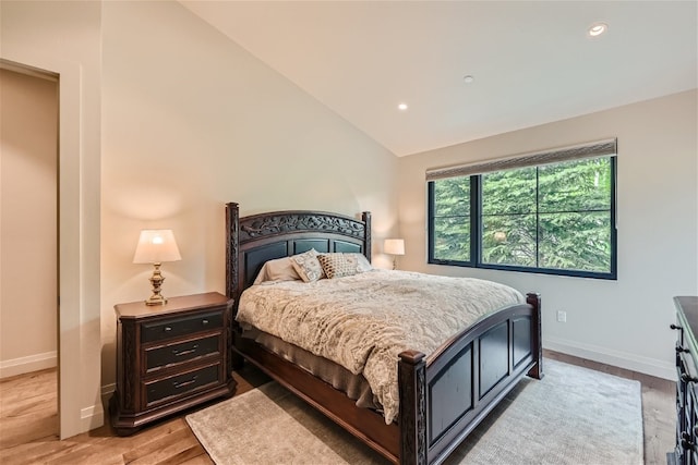 bedroom featuring light wood-type flooring, recessed lighting, baseboards, and lofted ceiling