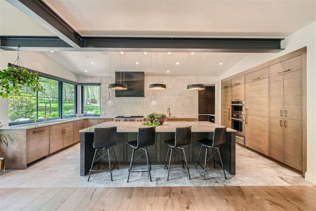 kitchen featuring a sink, modern cabinets, lofted ceiling with beams, and extractor fan