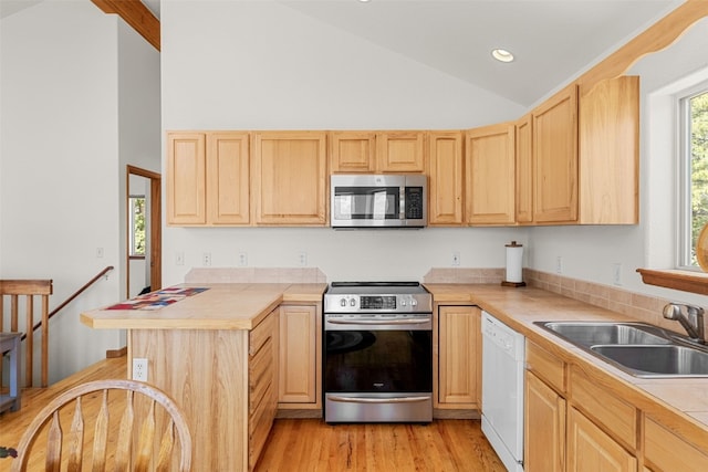 1576 Bobcat Ln, Fairplay, CO 80440 - kitchen with appliances with stainless steel finishes, light brown cabinets, light wood finished floors, tile countertops, and recessed lighting