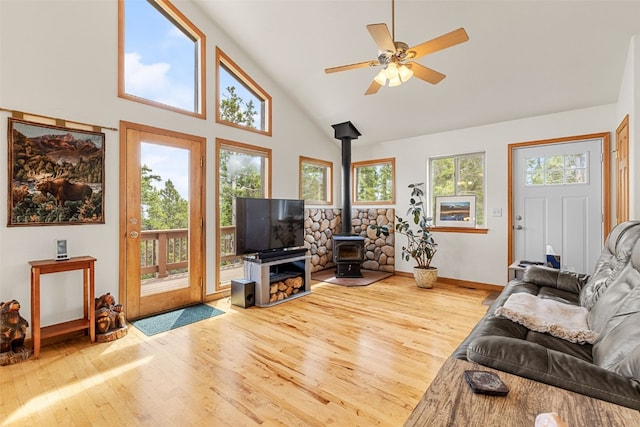 1576 Bobcat Ln, Fairplay, CO 80440 - living area with wood finished floors, a wood stove, plenty of natural light, high vaulted ceiling, and ceiling fan
