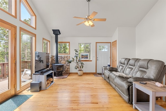 1576 Bobcat Ln, Fairplay, CO 80440 - living area with light wood finished floors, a wood stove, high vaulted ceiling, and ceiling fan
