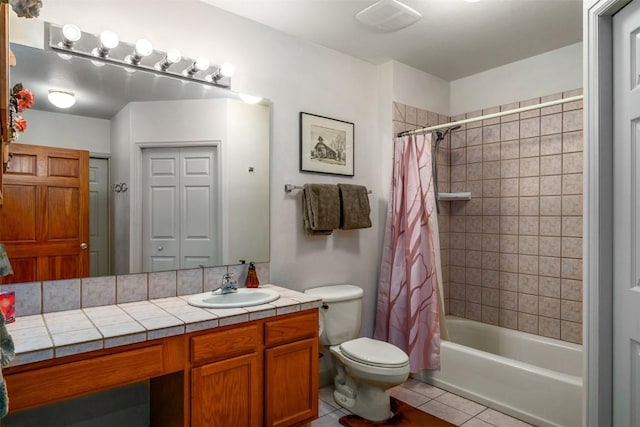 40870 Purple Sage St, Steamboat Springs, CO 80487 - bathroom with vanity, toilet, tile patterned floors, and shower / bath combo with shower curtain