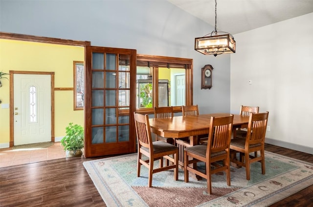 40870 Purple Sage St, Steamboat Springs, CO 80487 - dining room with high vaulted ceiling, a chandelier, baseboards, wood finished floors, and healthy amount of natural light