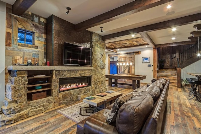 19 Peak 8 Ct, Breckenridge, CO 80424 - living area with wood-type flooring, beam ceiling, and a stone fireplace