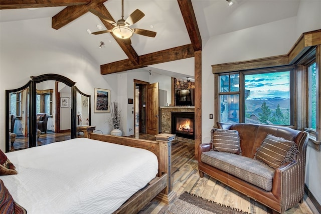 19 Peak 8 Ct, Breckenridge, CO 80424 - bedroom with wood finished floors, beamed ceiling, a large fireplace, and high vaulted ceiling