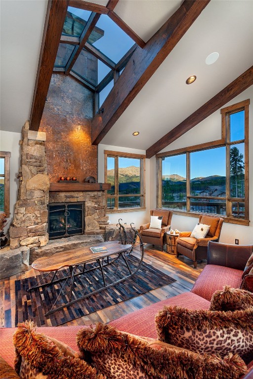 19 Peak 8 Ct, Breckenridge, CO 80424 - living area featuring wood finished floors, a stone fireplace, and recessed lighting