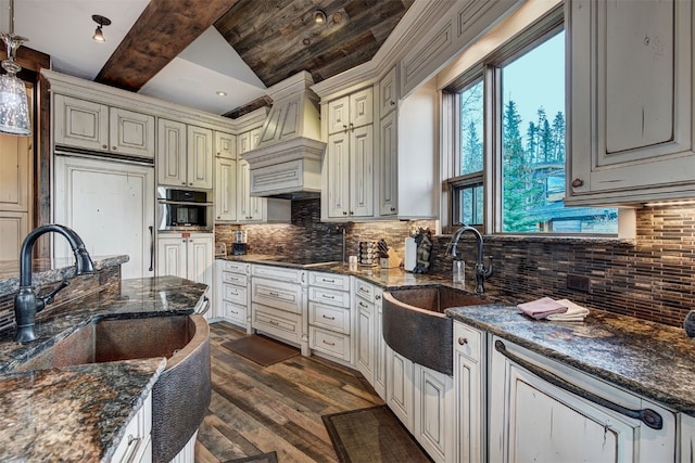 19 Peak 8 Ct, Breckenridge, CO 80424 - kitchen featuring custom range hood, cream cabinetry, dark wood-style flooring, and tasteful backsplash