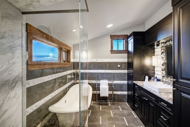 19 Peak 8 Ct, Breckenridge, CO 80424 - bathroom with tile walls, a freestanding tub, vanity, plenty of natural light, and recessed lighting
