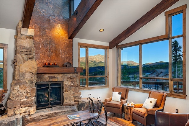 19 Peak 8 Ct, Breckenridge, CO 80424 - living area with beam ceiling, wood finished floors, a fireplace, a mountain view, and high vaulted ceiling