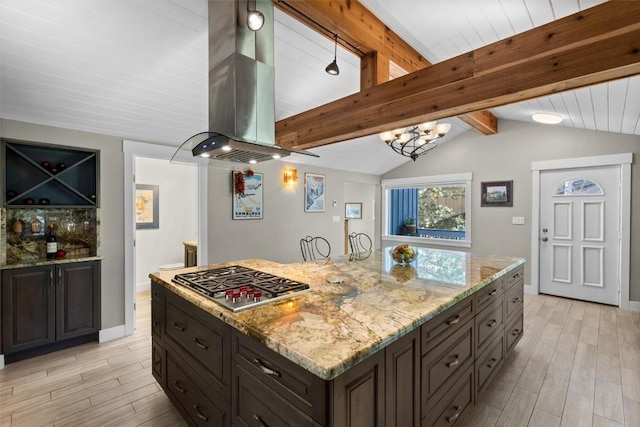 862 Douglas St, Steamboat Springs, CO 80487 - kitchen with stainless steel gas cooktop, island range hood, light wood finished floors, and light stone countertops