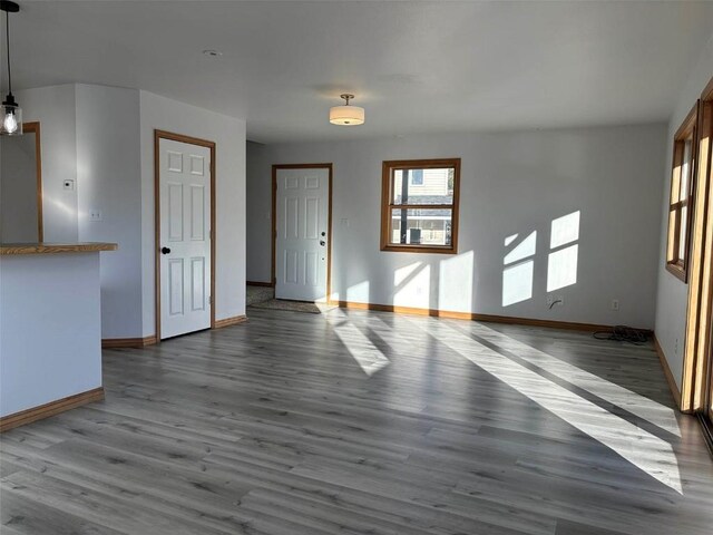 1550 Red Hawk Ct, Steamboat Springs, CO 80487 - unfurnished living room featuring wood finished floors and baseboards