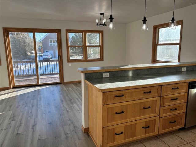 1550 Red Hawk Ct, Steamboat Springs, CO 80487 - kitchen with light wood-type flooring, baseboards, a notable chandelier, and hanging light fixtures