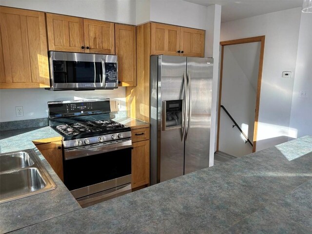 1550 Red Hawk Ct, Steamboat Springs, CO 80487 - kitchen featuring brown cabinets, stainless steel appliances, and a sink