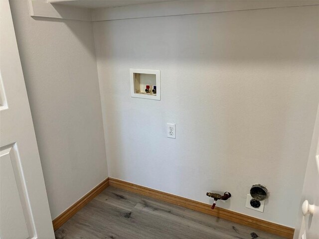 1550 Red Hawk Ct, Steamboat Springs, CO 80487 - laundry room with baseboards, hookup for a washing machine, wood finished floors, electric dryer hookup, and laundry area