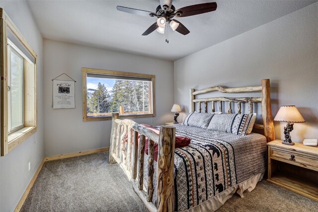 carpeted bedroom with baseboards and a ceiling fan