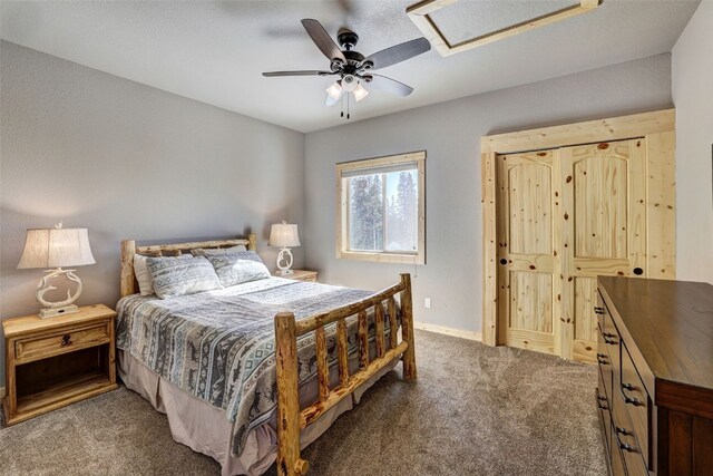 bedroom with carpet floors, attic access, baseboards, and a ceiling fan