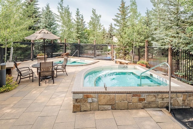 1463 Flattop Cir Unit 302, Steamboat Springs, CO 80487 - view of pool with a hot tub, a patio area, and a swimming pool