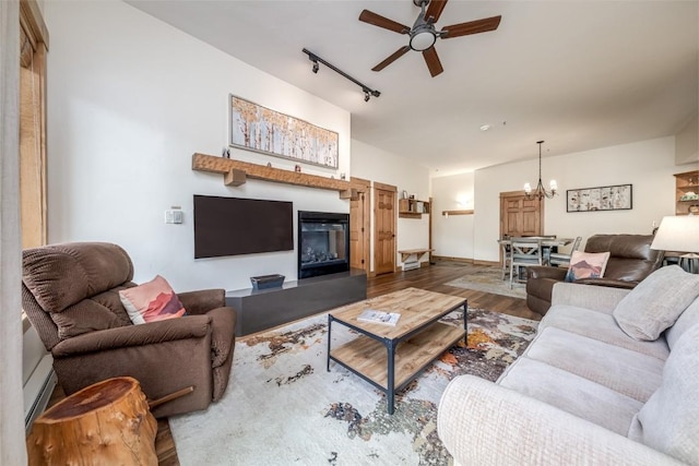 1463 Flattop Cir Unit 302, Steamboat Springs, CO 80487 - living room with ceiling fan, a chandelier, wood finished floors, track lighting, and a baseboard radiator