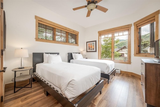 1463 Flattop Cir Unit 302, Steamboat Springs, CO 80487 - bedroom with wood finished floors and a baseboard radiator