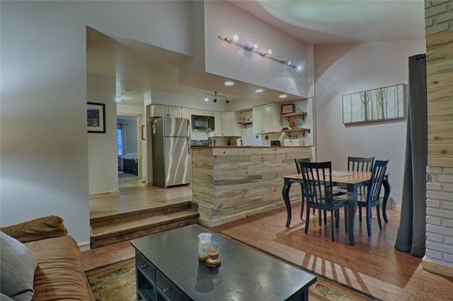 246 Broken Lance Dr Unit 203, Breckenridge, CO 80424 - living area featuring light wood-type flooring, vaulted ceiling, and baseboards