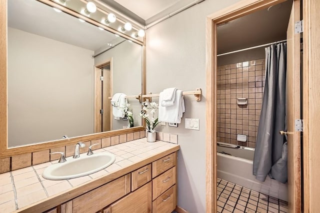 full bathroom with shower / bath combo with shower curtain, tile patterned floors, and vanity