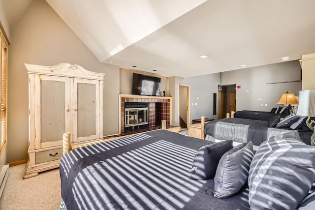 carpeted bedroom with a baseboard radiator, lofted ceiling, and a tiled fireplace