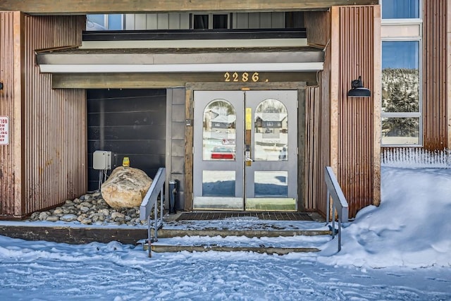 view of snow covered property entrance