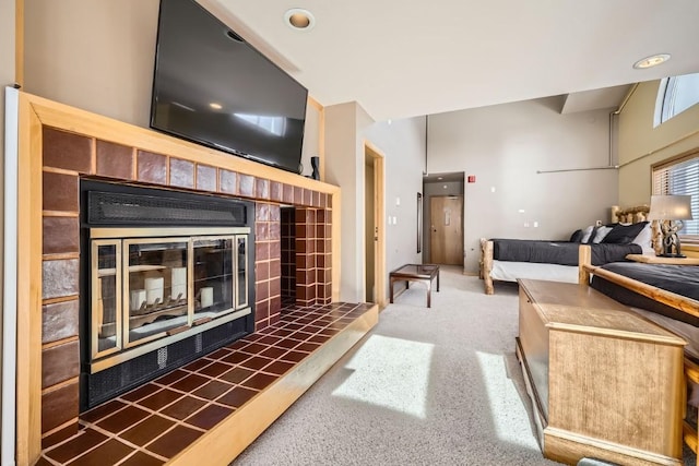 living room with carpet floors and a tiled fireplace