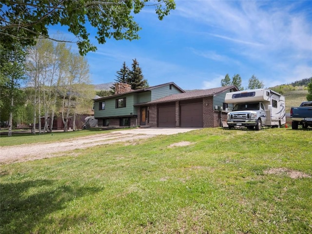 1346 Rainbow Dr, Silverthorne, CO 80498 - tri-level home featuring a chimney, brick siding, an attached garage, a front yard, and driveway