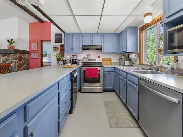 1346 Rainbow Dr, Silverthorne, CO 80498 - kitchen with stainless steel appliances, a paneled ceiling, light countertops, under cabinet range hood, and blue cabinetry