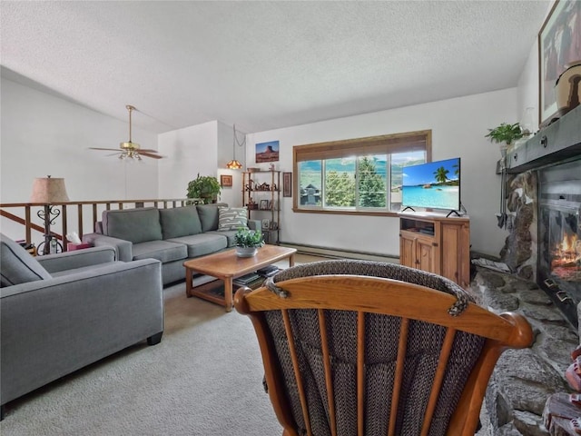1346 Rainbow Dr, Silverthorne, CO 80498 - living area with a textured ceiling, light colored carpet, a glass covered fireplace, a baseboard radiator, and ceiling fan
