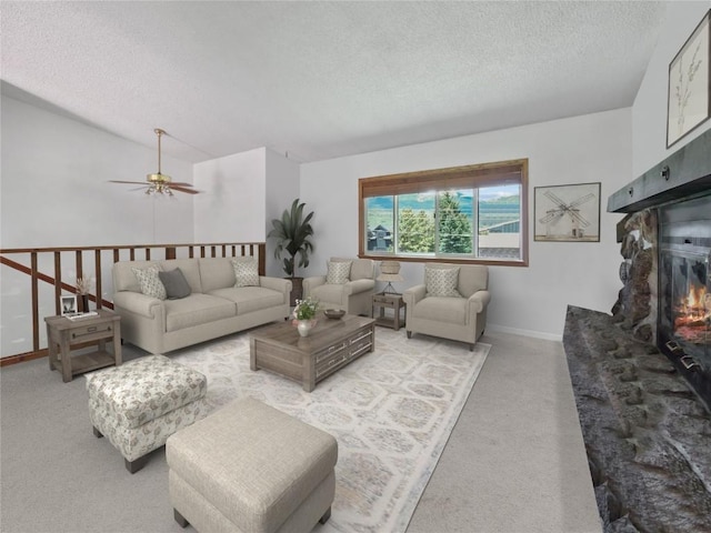 1346 Rainbow Dr, Silverthorne, CO 80498 - living area with a textured ceiling, light carpet, ceiling fan, and a glass covered fireplace