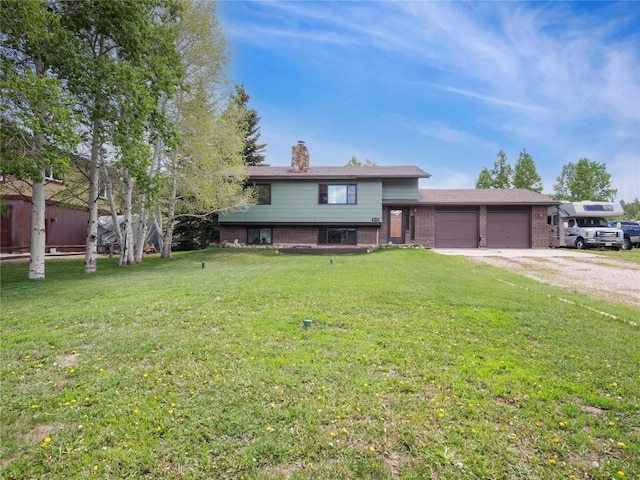 1346 Rainbow Dr, Silverthorne, CO 80498 - tri-level home featuring brick siding, an attached garage, driveway, a chimney, and a front yard