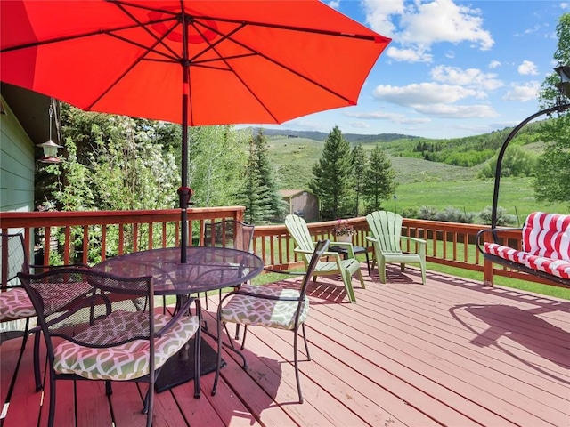 1346 Rainbow Dr, Silverthorne, CO 80498 - wooden terrace featuring outdoor dining area and a forest view