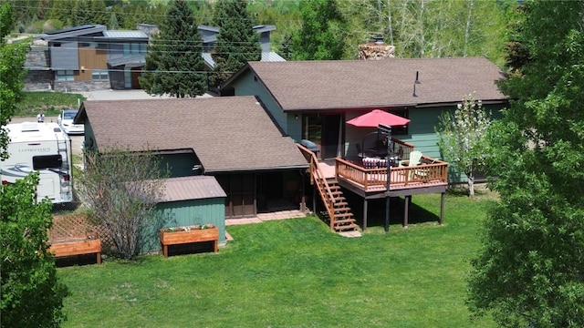 1346 Rainbow Dr, Silverthorne, CO 80498 - rear view of property with a shingled roof, a wooden deck, a chimney, and a lawn