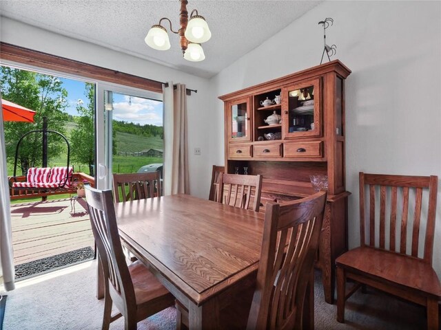 1346 Rainbow Dr, Silverthorne, CO 80498 - carpeted dining room with a chandelier and a textured ceiling