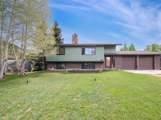 1346 Rainbow Dr, Silverthorne, CO 80498 - split level home with brick siding, a garage, a chimney, a front lawn, and concrete driveway