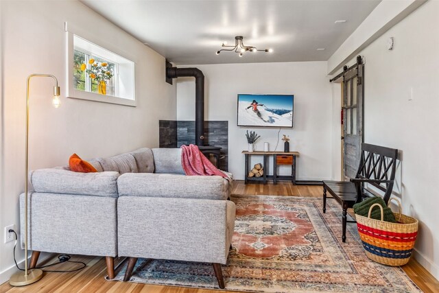 530 Castello Ave, Fairplay, CO 80440 - living area with a barn door, a wood stove, wood finished floors, and baseboards