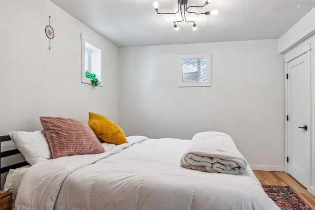 530 Castello Ave, Fairplay, CO 80440 - bedroom with light wood-type flooring, baseboards, and a chandelier