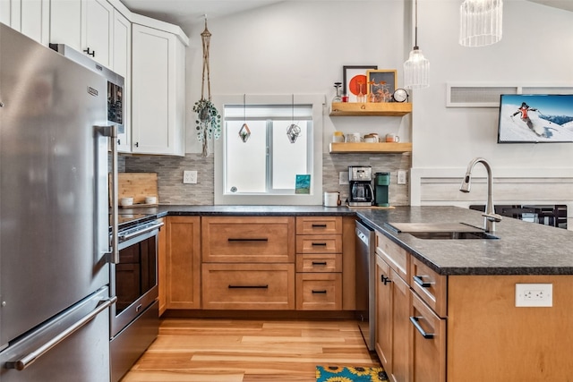 530 Castello Ave, Fairplay, CO 80440 - kitchen with appliances with stainless steel finishes, a sink, light wood finished floors, tasteful backsplash, and white cabinets