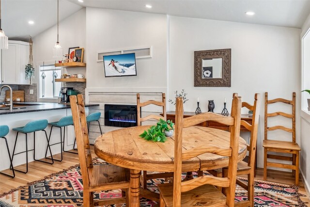 530 Castello Ave, Fairplay, CO 80440 - dining room featuring light wood-style floors, vaulted ceiling, recessed lighting, and a glass covered fireplace