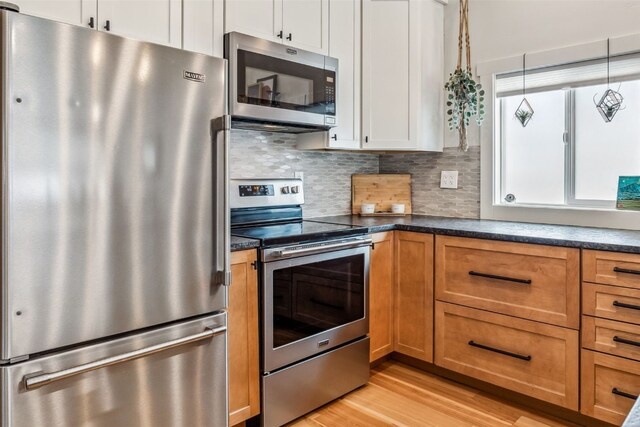 530 Castello Ave, Fairplay, CO 80440 - kitchen featuring stainless steel appliances, light wood finished floors, and dark countertops