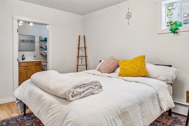 530 Castello Ave, Fairplay, CO 80440 - bedroom featuring light wood finished floors, a baseboard radiator, and wet bar