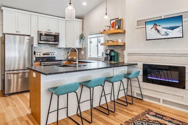 530 Castello Ave, Fairplay, CO 80440 - kitchen featuring appliances with stainless steel finishes, a sink, decorative backsplash, light wood finished floors, and recessed lighting
