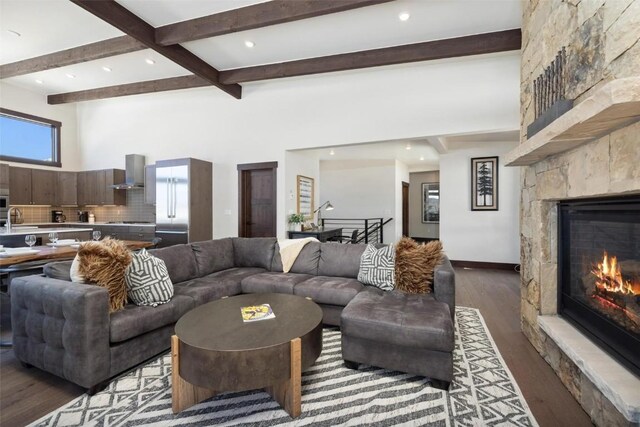 11 Glazer Trl, Silverthorne, CO 80498 - living area with a large fireplace, beam ceiling, recessed lighting, wood finished floors, and a high ceiling